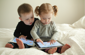 kids-playing-educational-apps-on-tablet-device-300x194