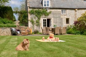 A charming house featuring a large stone structure, showcasing rustic architecture and a welcoming atmosphere