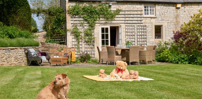 A charming house featuring a large stone structure, showcasing rustic architecture and a welcoming atmosphere