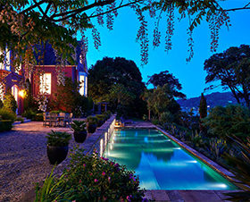 Big House with a beautiful swimming pool at night in Devon.