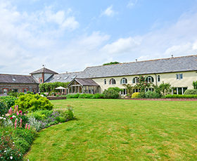 Large luxury house with a green lawn in Wiltshire.