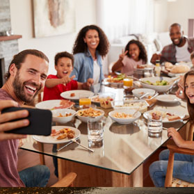 Two families enjoying a meal together.