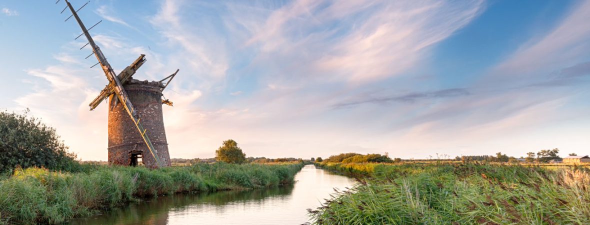 Windmill next to a river in Norfolk.