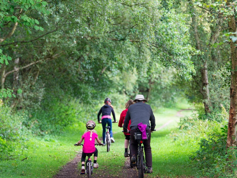 Family cycling off-road.