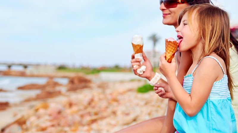 Mum and daughter enjoying an ice cream together.