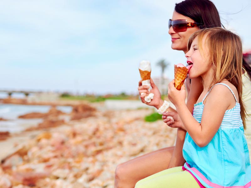 Mum and daughter enjoying an ice cream together.