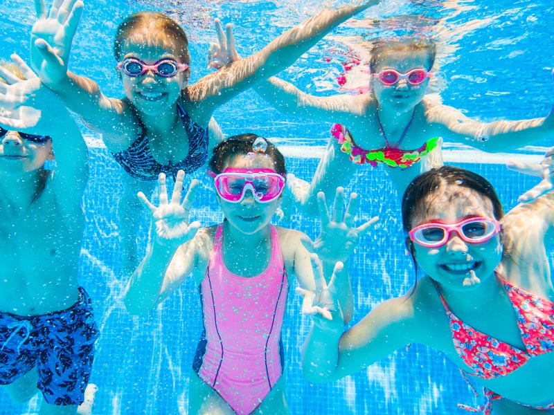 Kids enjoying the swimming pool.