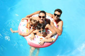 Family in a swimming pool having fun!