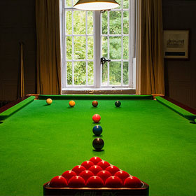 Snooker table in a games room.