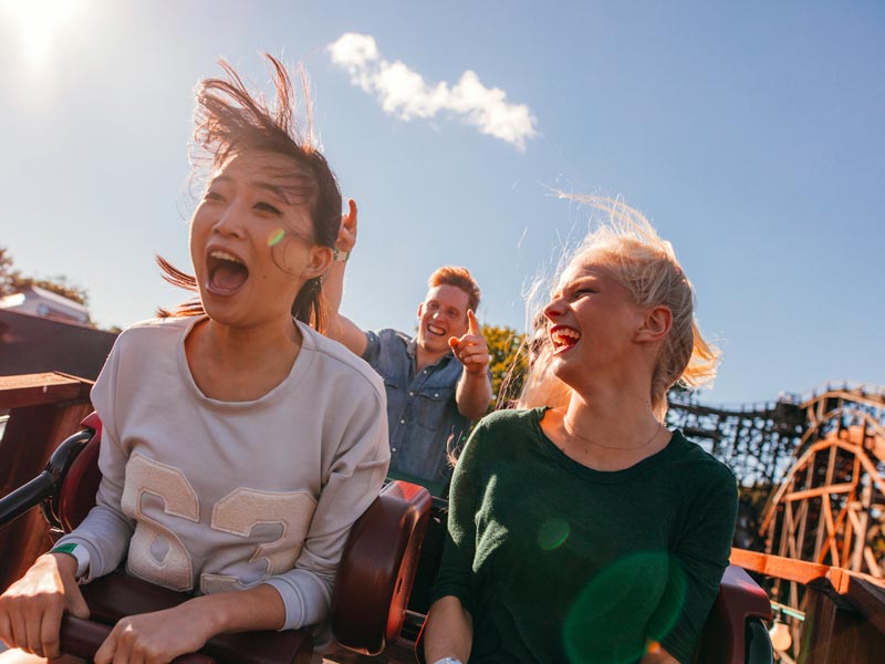 3 friends having fun on a roller coaster.