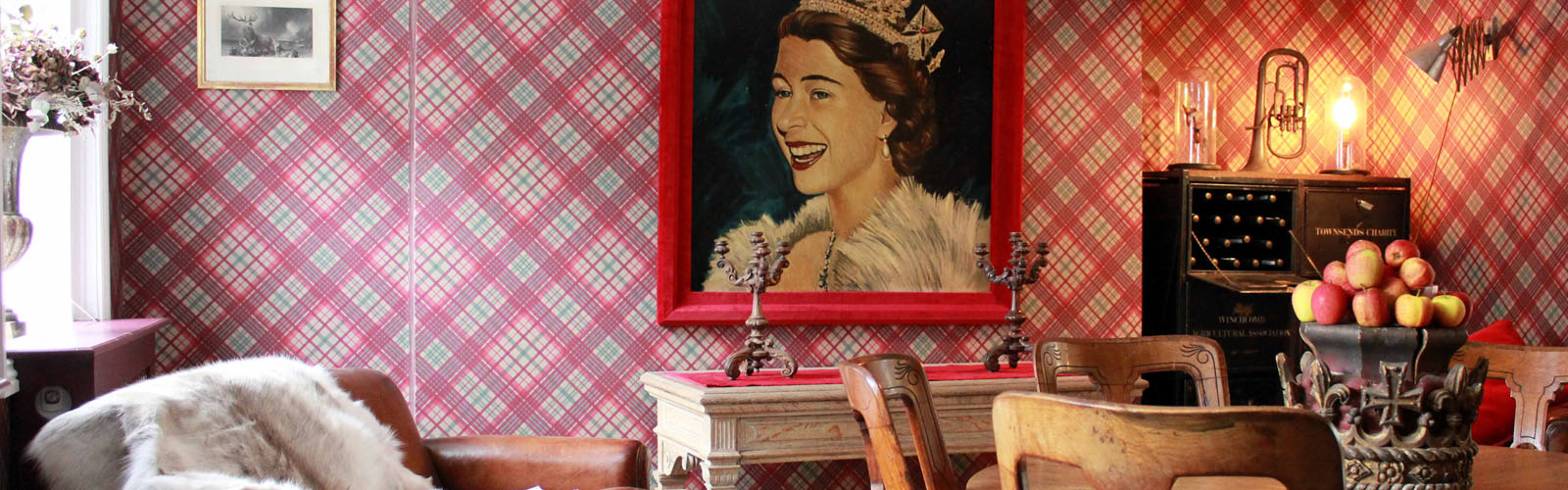 Unusual dining room with a painting of the Queen.