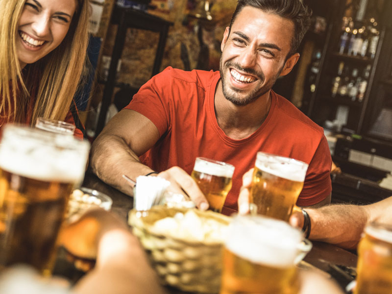 Friends enjoying a drink in a pub.