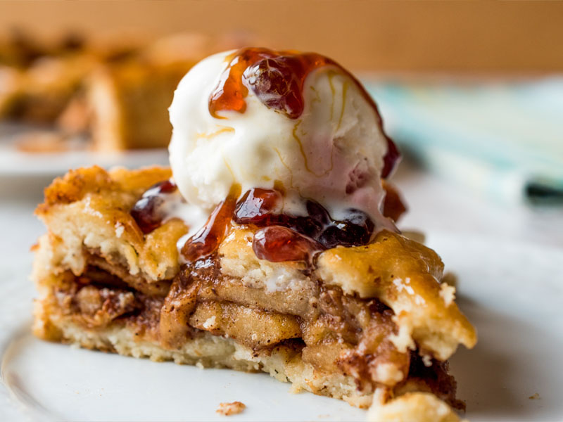 Canterbury apple tart with ice cream on it.