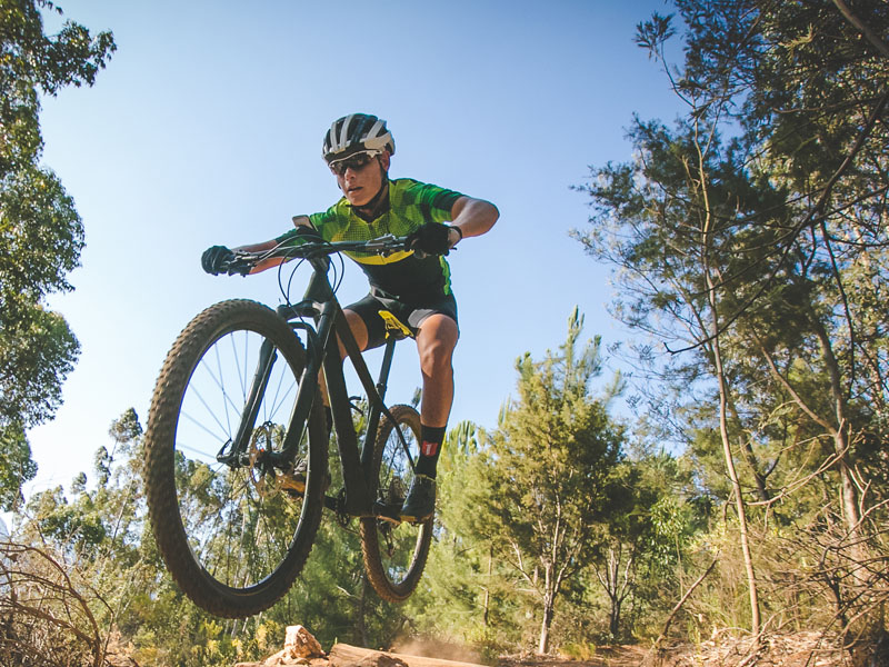 Mountain biker speeding downhill.