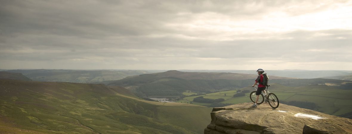 Mountain biker looking over the Peak District.