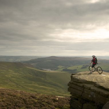 Mountain biker looking over the Peak District.