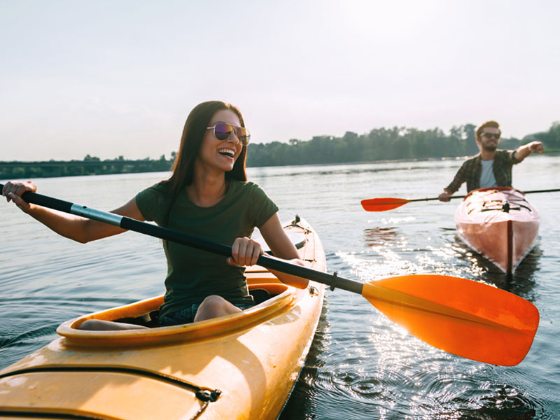 Couple kayaking on a lake, Shropshire