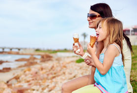 Mum and daughter enjoy an ice cream on a summer holiday.