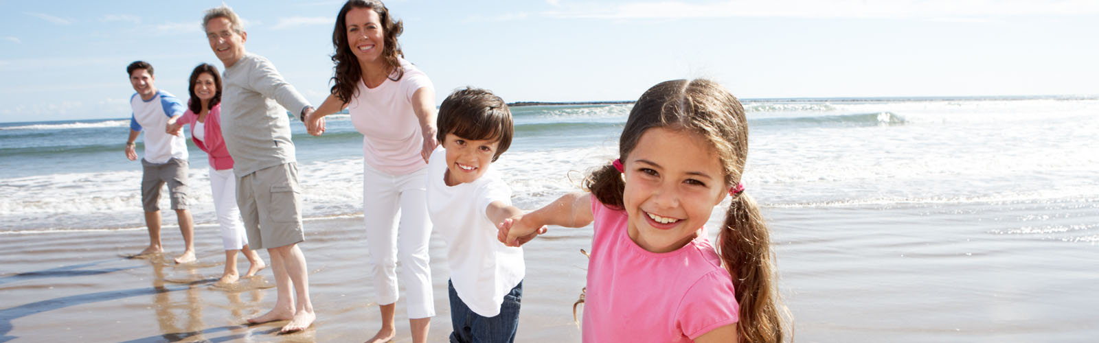 Family enjoying a summer holiday on a beach.