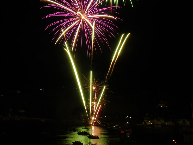 Fireworks reflecting in the waters of Salcombe harbour.