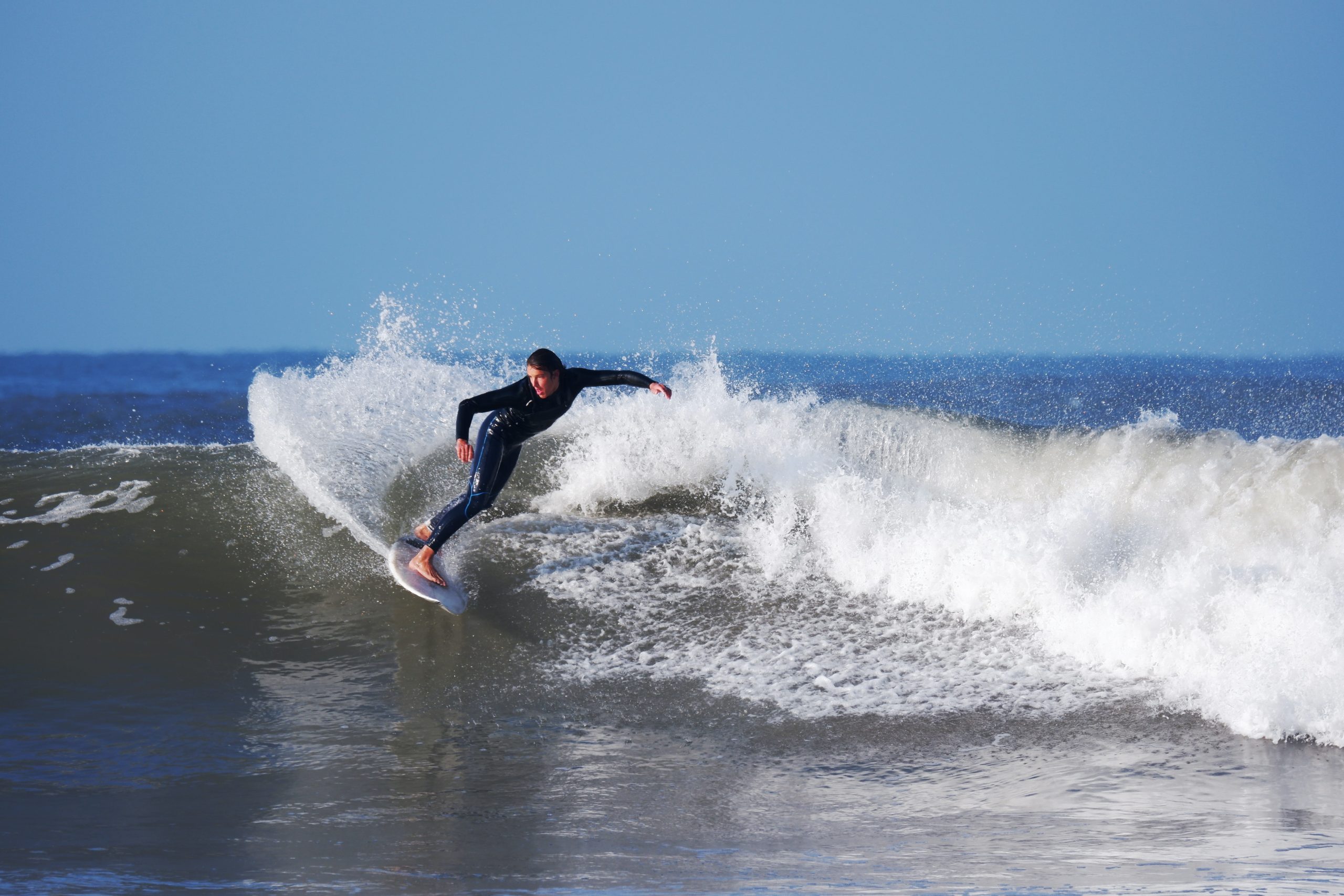 Hayle,Cornwall,7th March 2021,Surfers enjoy the 12ft waves along