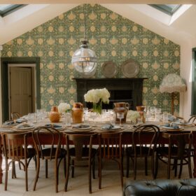 A dining room featuring green wallpaper and a skylight, creating a bright and inviting atmosphere