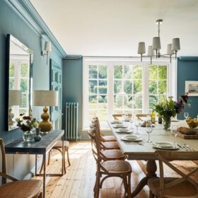 A luxury dining room with a set dinner table ready to entertain guests