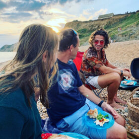 A group of friends enjoying a BBQ on a beach